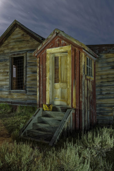 Front door of abandoned house at night in Bodie California