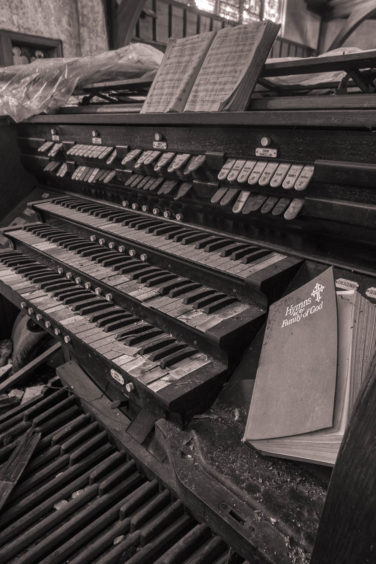 Organ and hymnal at abandoned church in Chester Pennsylvania