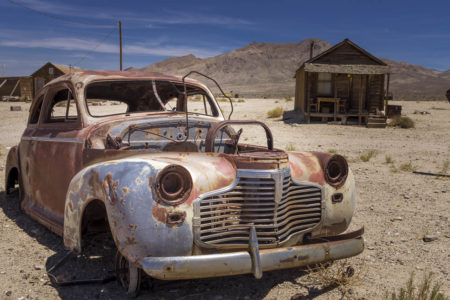 Abandoned car and house in Goldpoint California ghost town