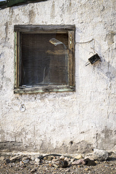 This is the outside of an abandoned house in the ghost town of Rhyolite Nevada.