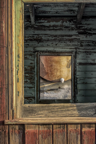 This is a scene through the window of a caboose in the ghost town of Rhyolite Nevada