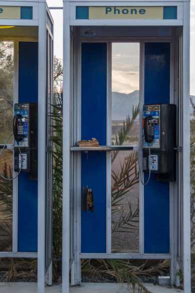 Telephone booths with mountains in background in Death Valley California