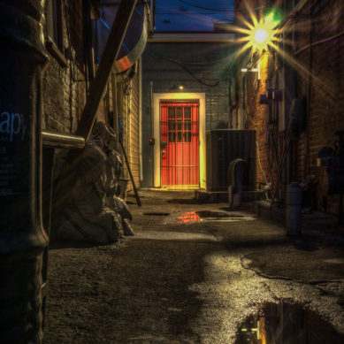 Alley at night in Leesburg Virginia with red door