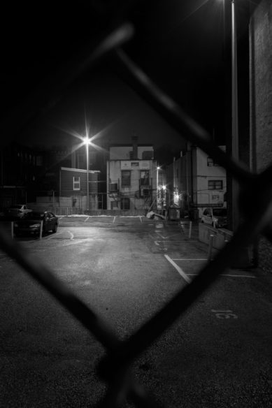Looking through a fence in Manayunk Pennsylvania at night