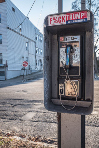 Pay telephone with political sign in Paterson New Jersey