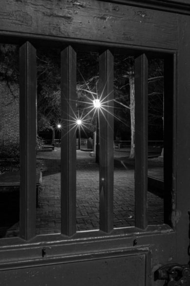Gate to Williamsburg Virginia churchyard at night